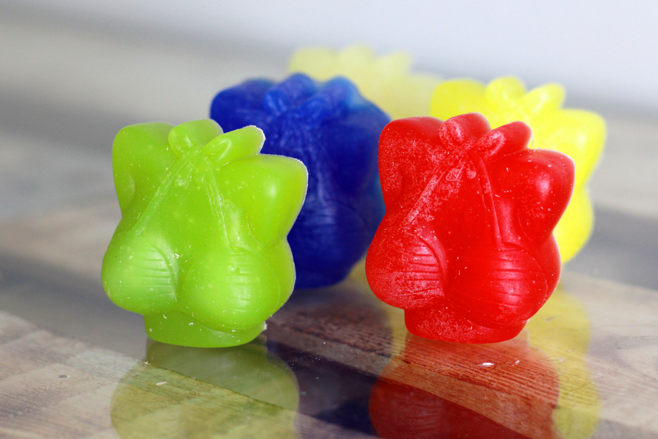 closeup of three gummy bears on glass surface