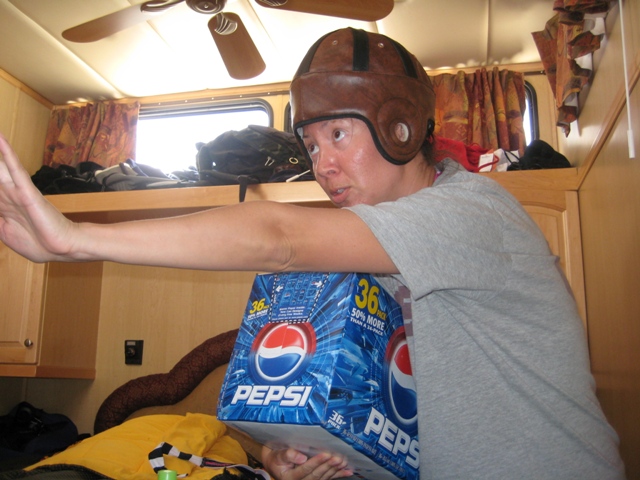 a person wearing a helmet holds a cooler