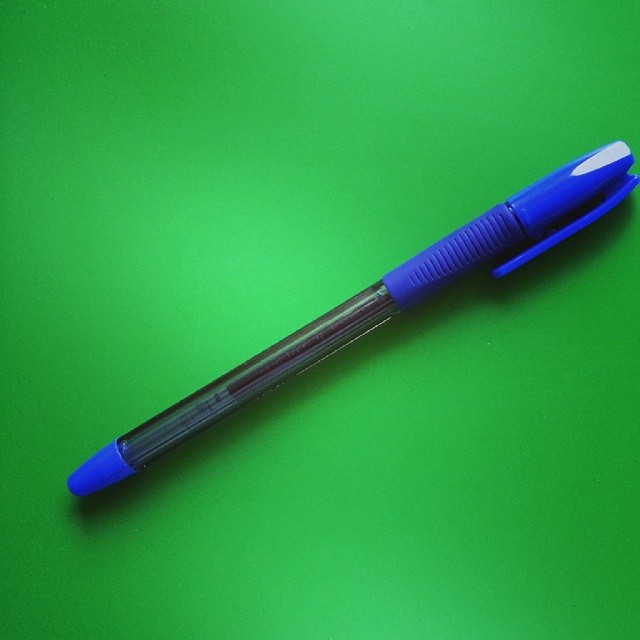 a pen sitting on top of a green table