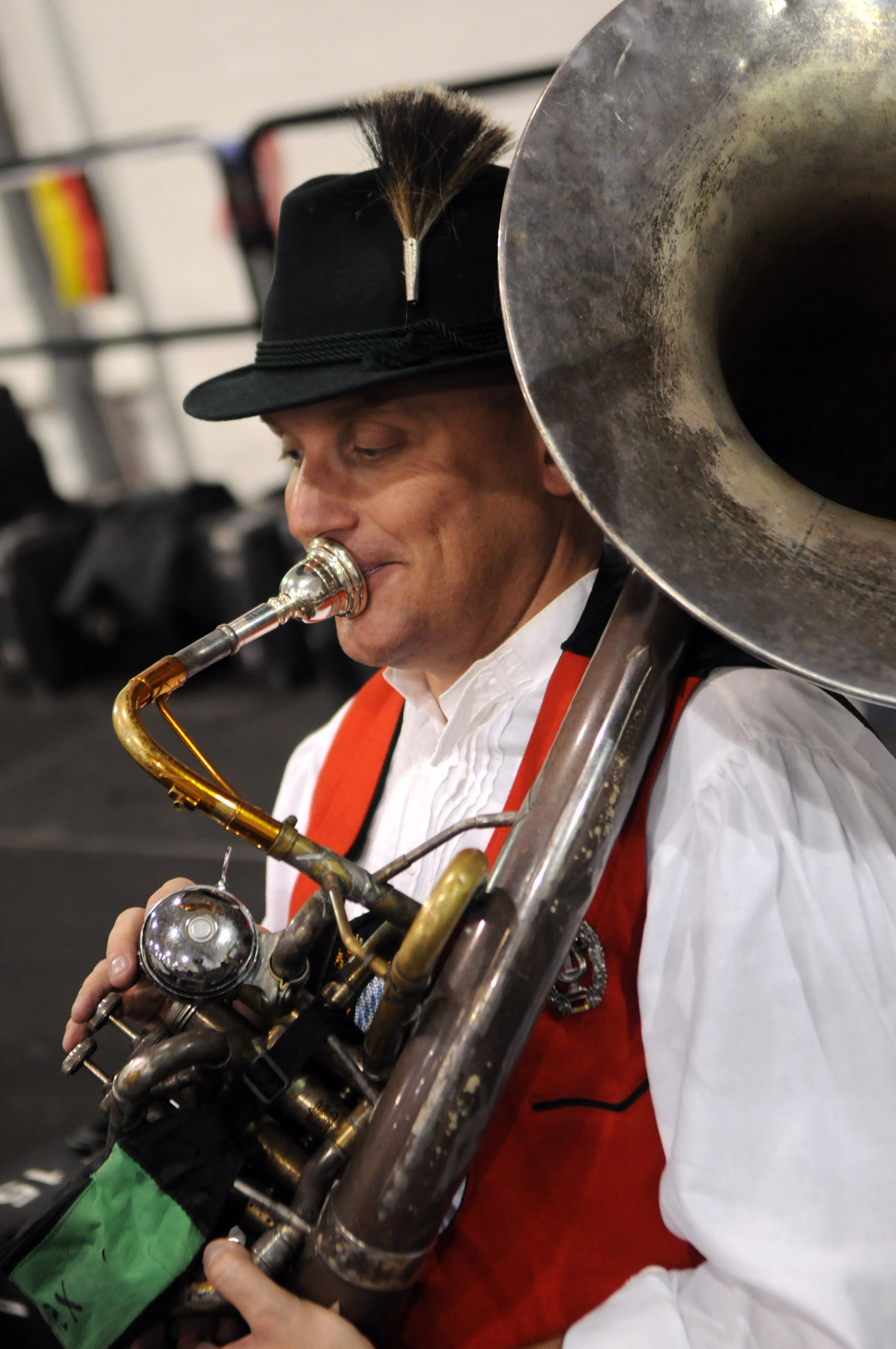 man playing musical instrument near crowd in indoor arena