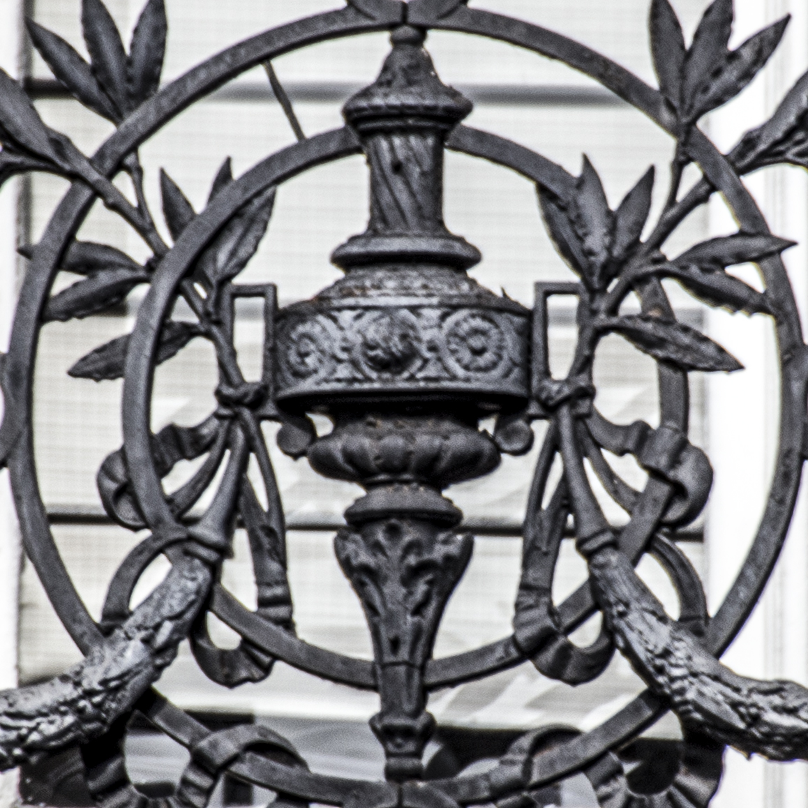 a decorative wrought iron work in front of an ornate building