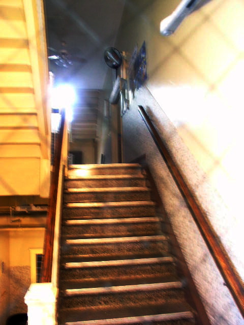 a narrow staircase leading to a second floor