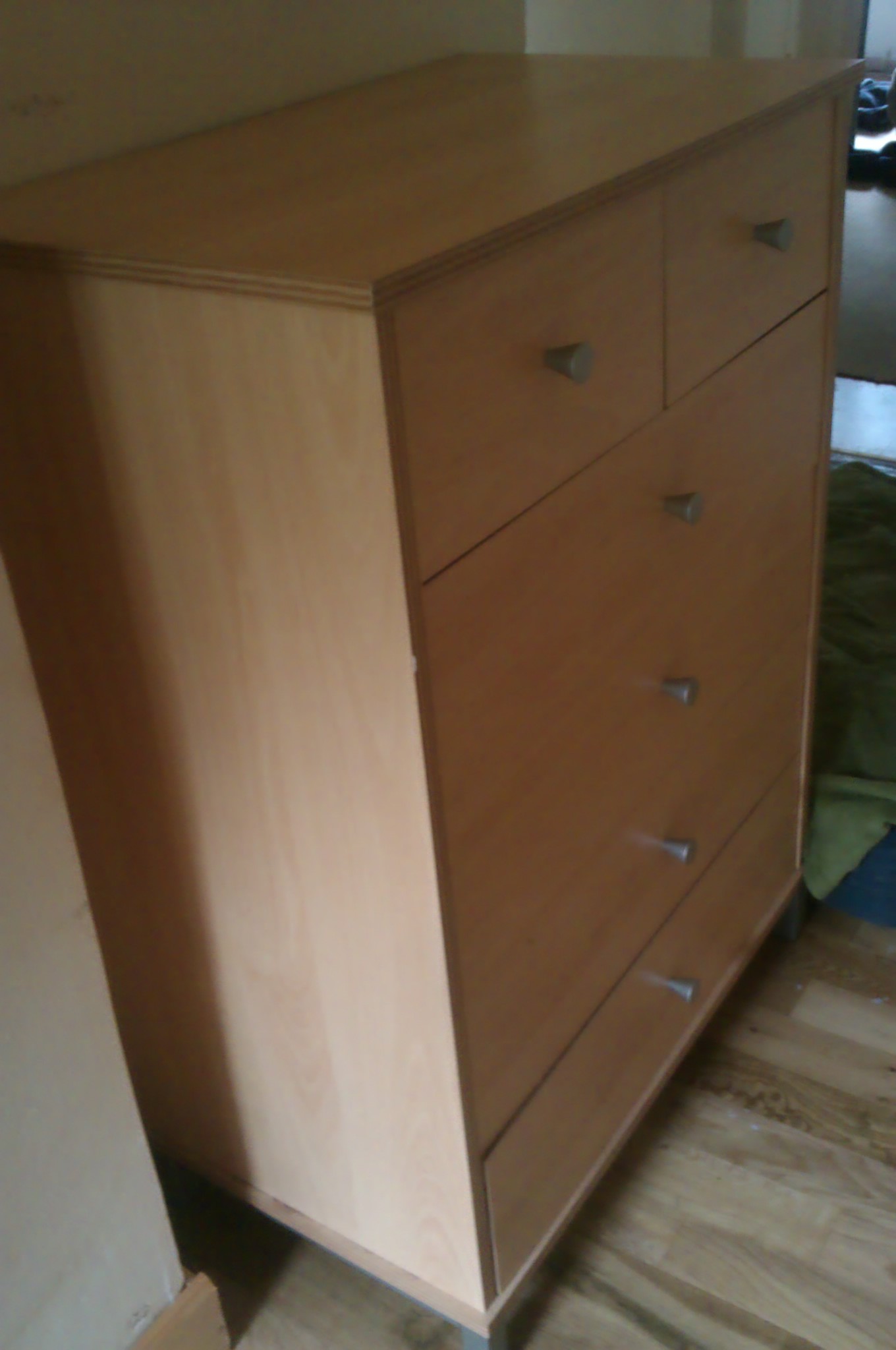 this is an empty brown dresser with five drawers