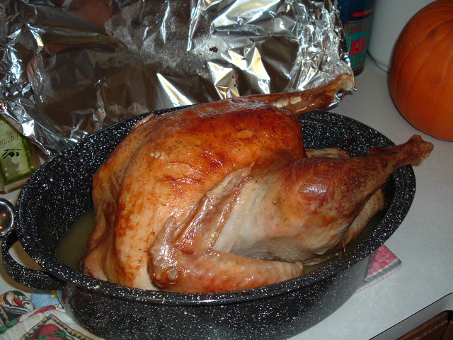 the roasted turkey is placed inside of the pot