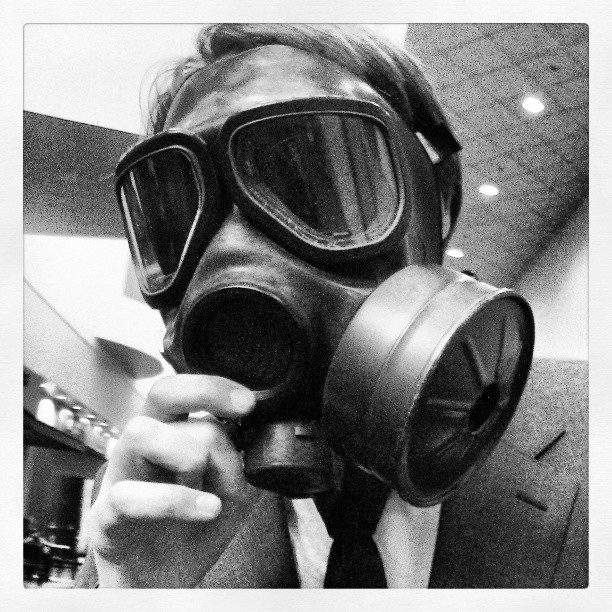 a man wearing a gas mask in a room