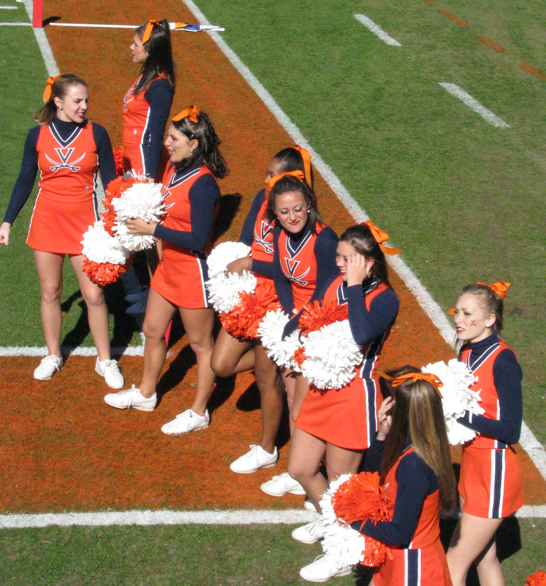 girls are dressed in cheerleader outfits on the field