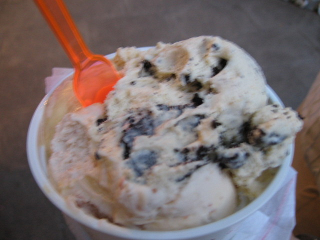 a cup filled with ice cream and an orange straw