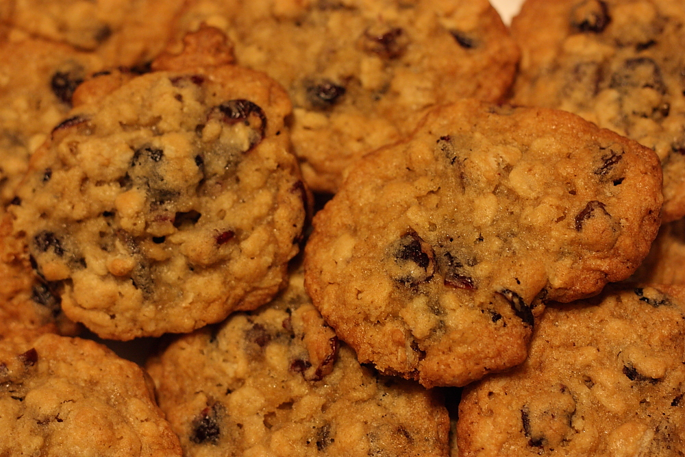 a pile of chocolate chip cookies sitting on top of a counter