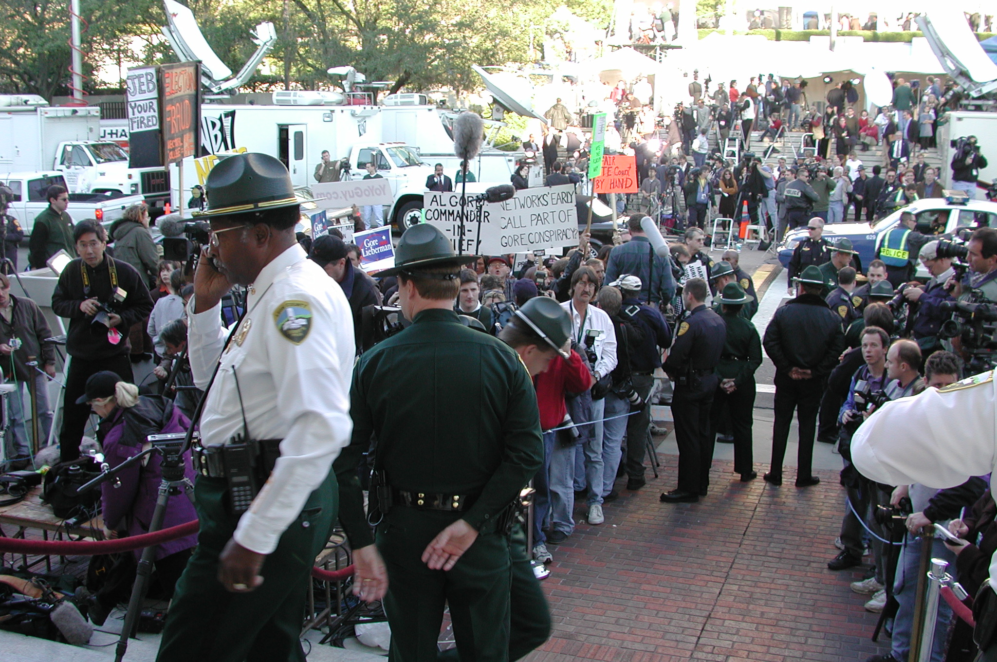 a group of police officers standing around in a crowd