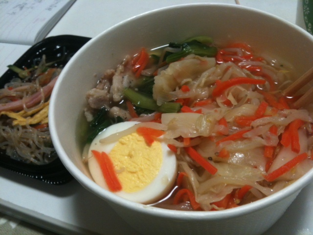 a bowl of noodles and some kind of egg next to a tray