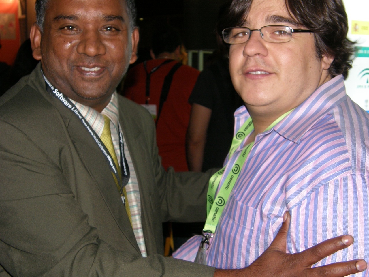 two men wearing different colored ties hugging each other