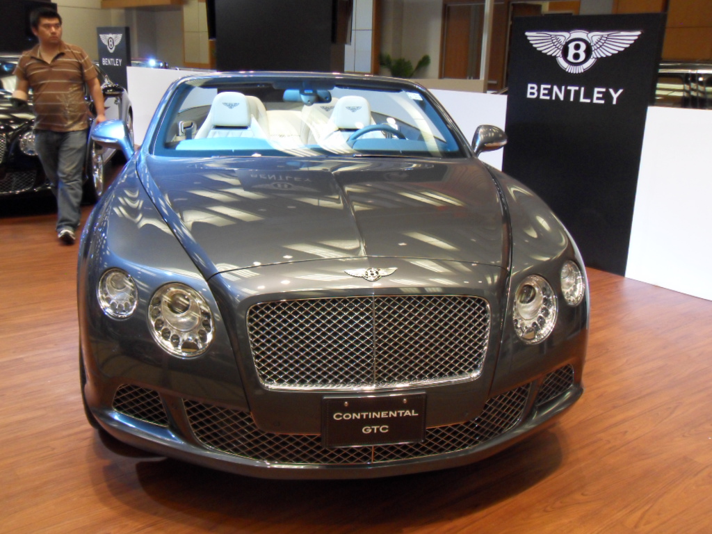 a bentley sits on display in a building