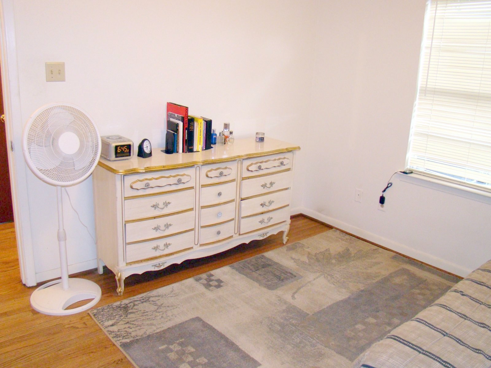 a white dresser with many books on top