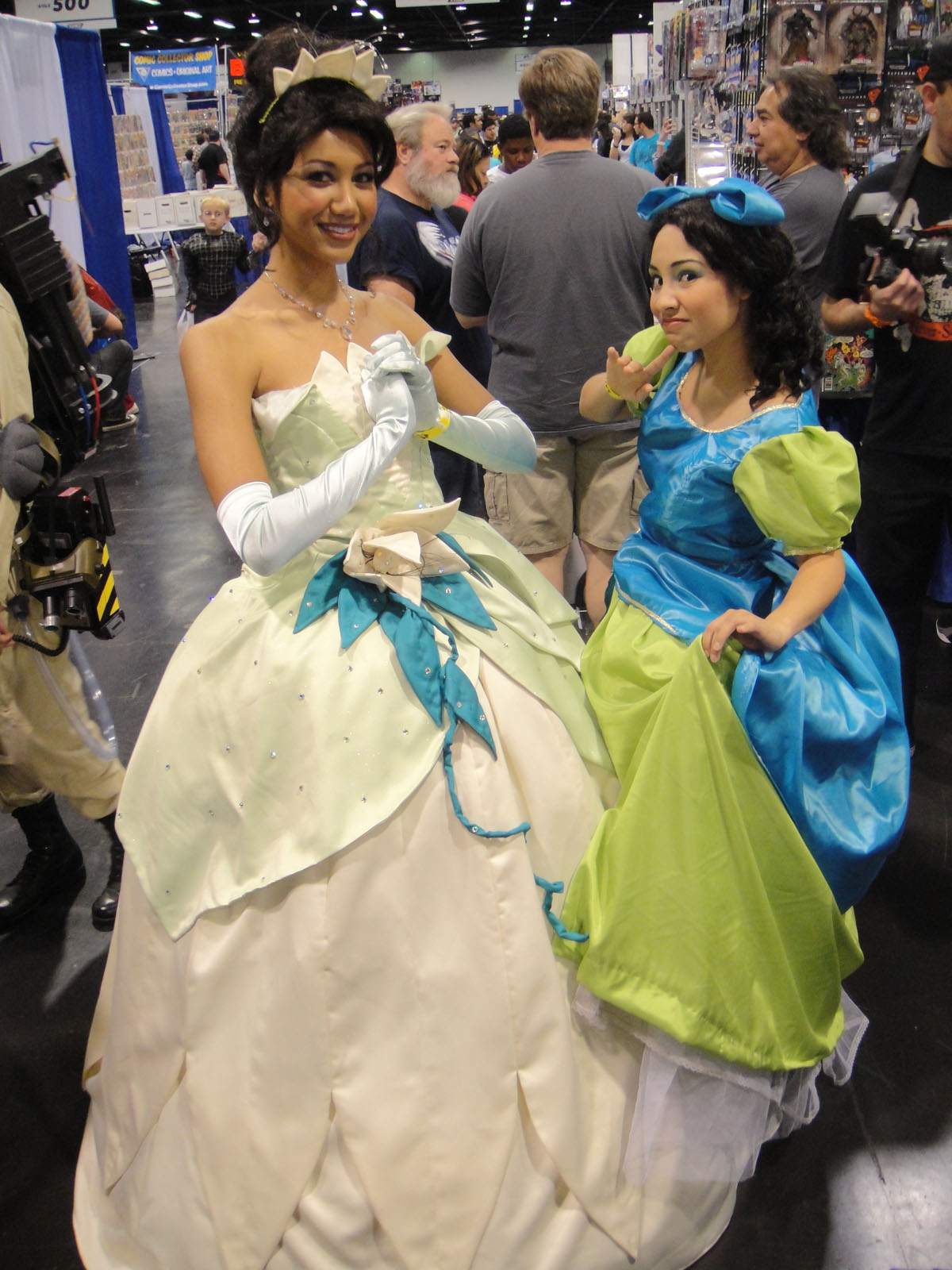 two women dressed in princess dresses look at each other
