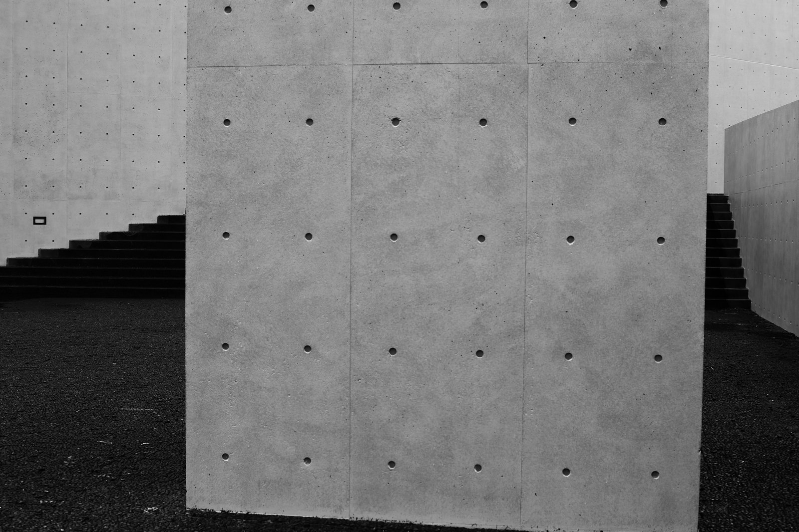 a concrete building with lots of dots on it