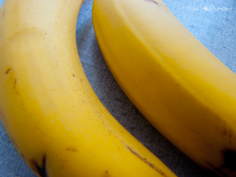 two bananas lying beside each other on a table