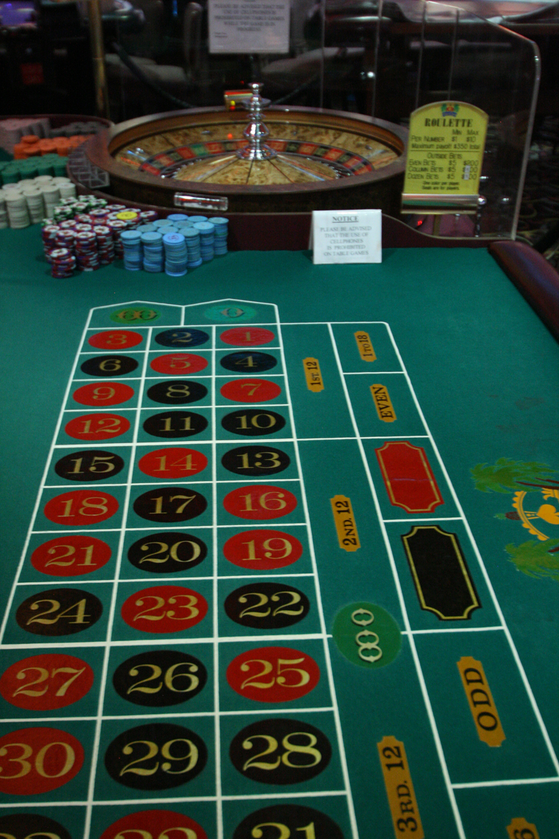 a table with casino games and chips sitting on it