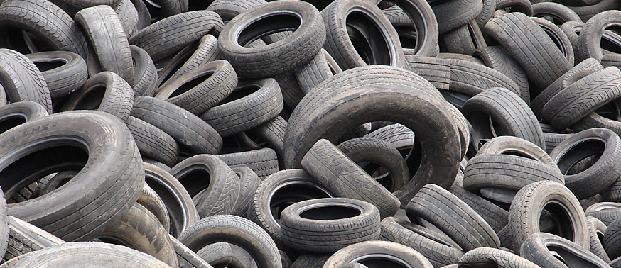 old worn tires and tires stacked up close together