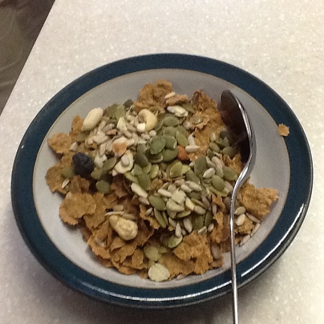 a bowl of cereal next to a spoon