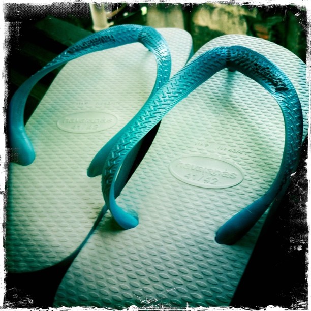 pair of blue slippers with turquoise handles
