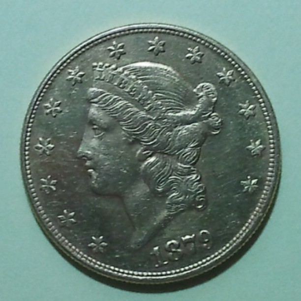 a large, ornate coin with a lady's face