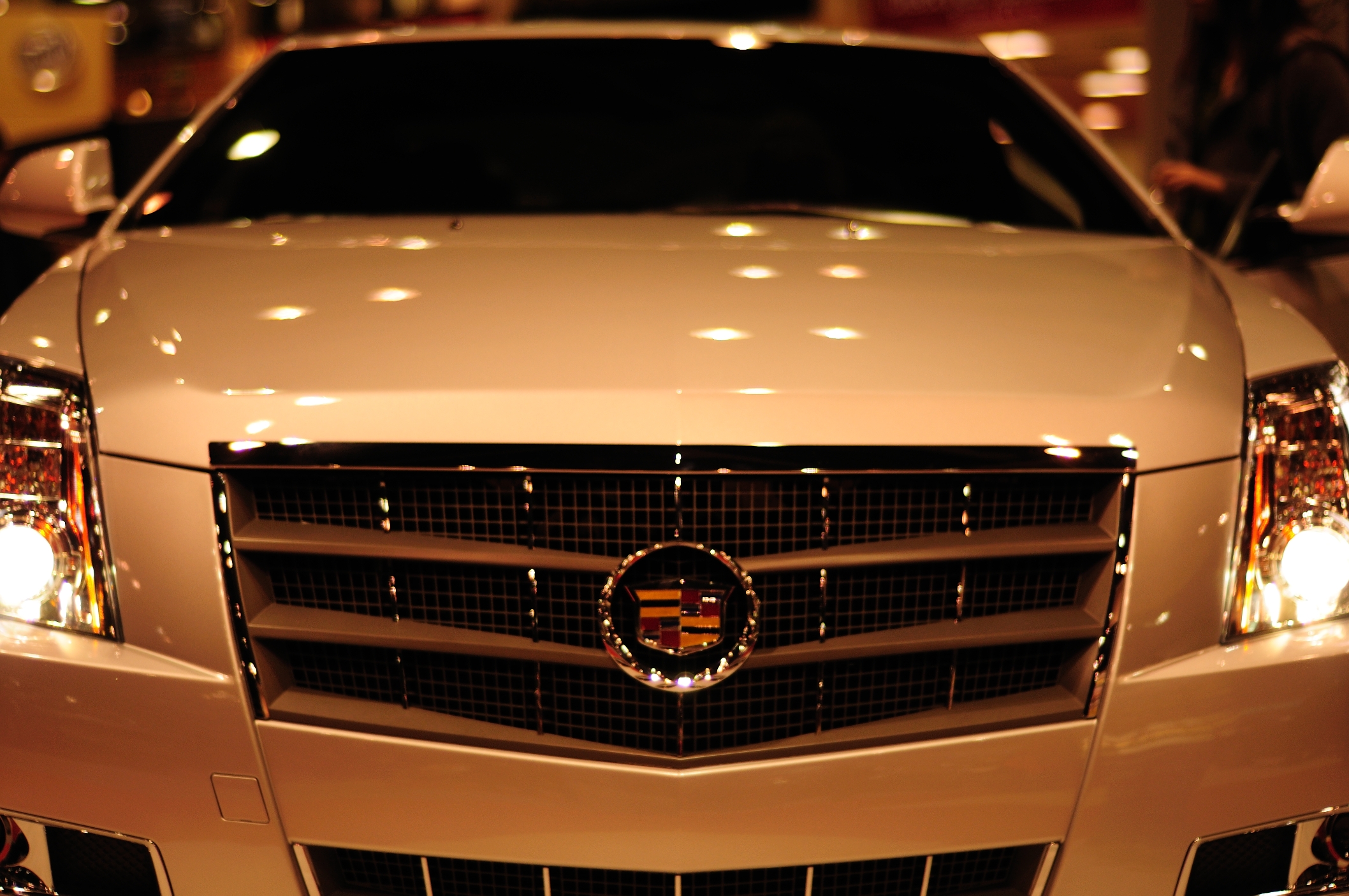 the grills on this white luxury vehicle are lit by lights