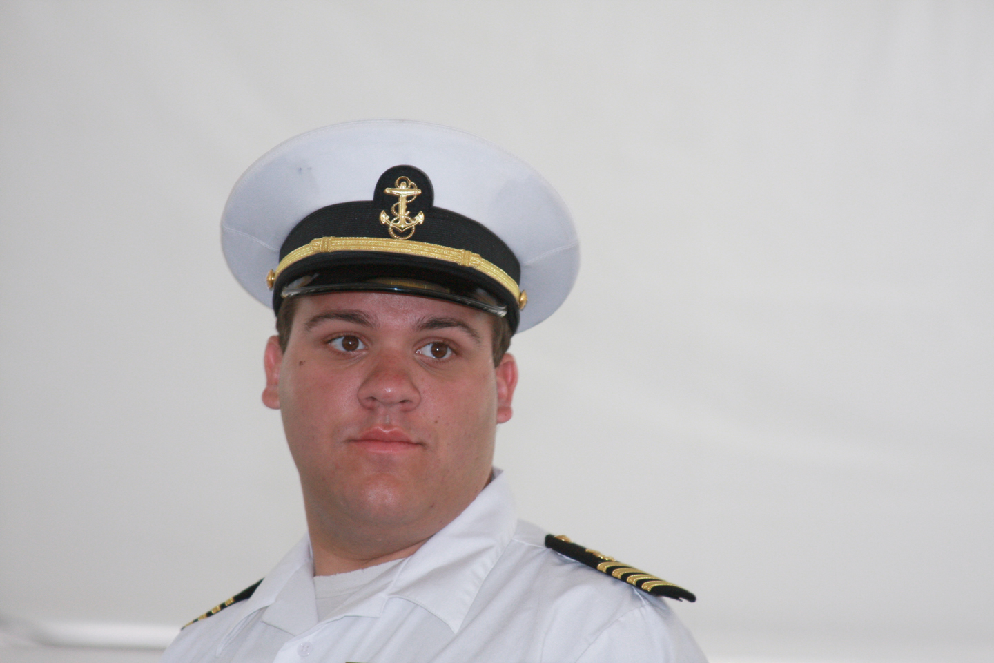 a sailor posing for a pograph wearing a uniform