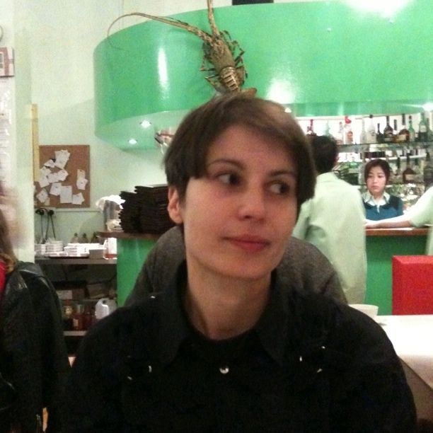 two women, one with short brown hair and one without the same , pose for a po