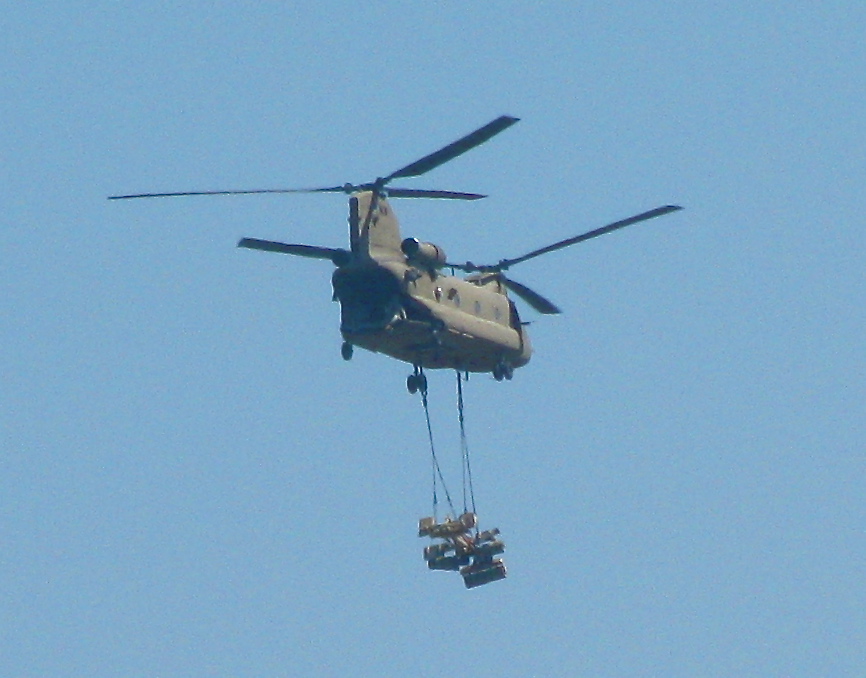 a helicopter holding another one as they jump