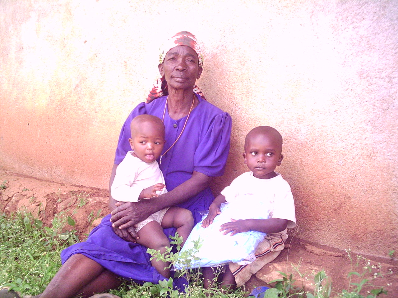an older woman and two children sitting together