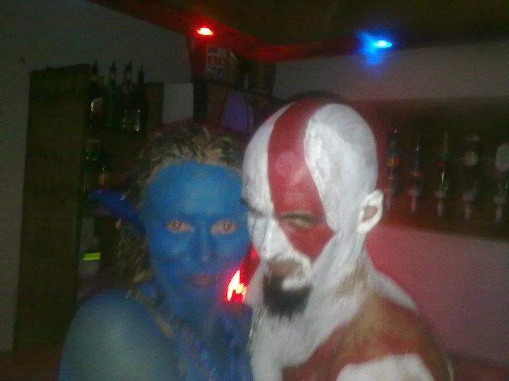 two people with blue paint on their faces posing for the camera