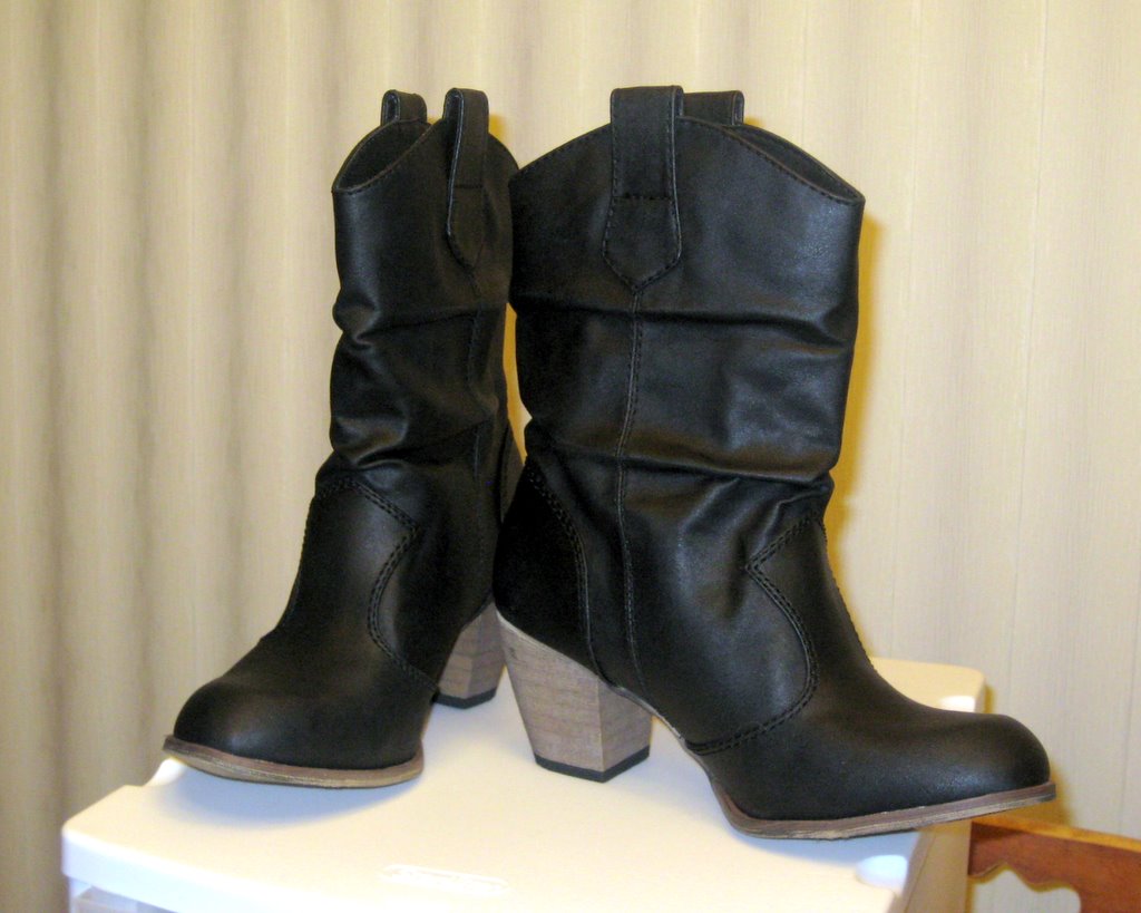 two black boots on top of a white table