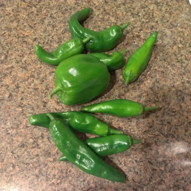green peppers are on the counter with the stems already cut