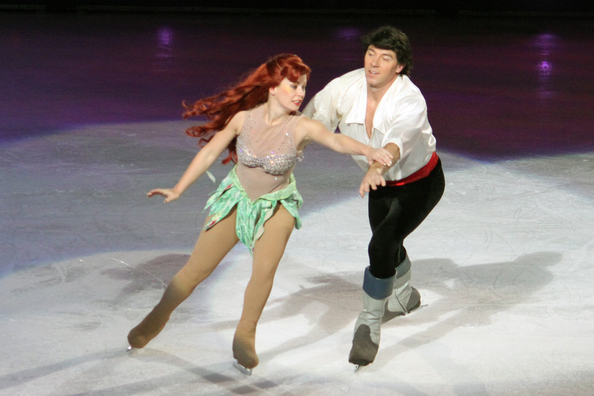 two young people are performing a figure skating stunt