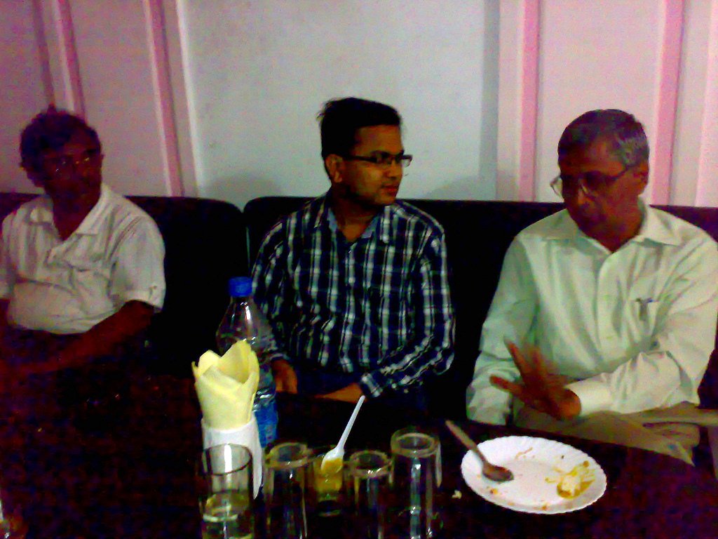 a couple of men are sitting at a table together