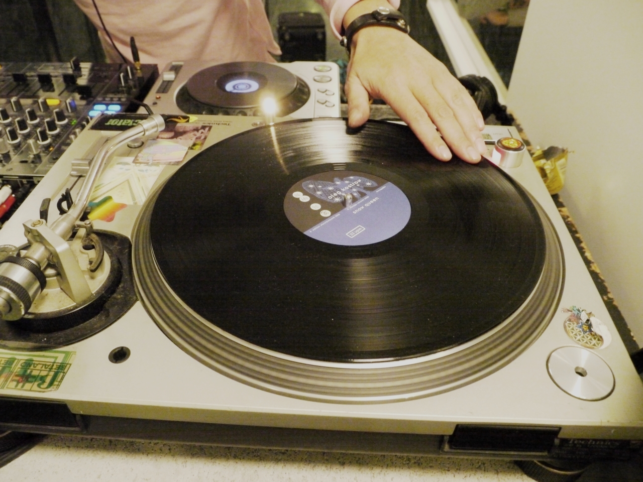 a person touching a record player on a table