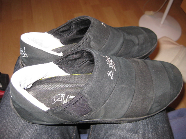 black shoes with white socks attached sitting on a chair