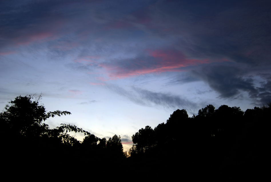 dark, colorful, cloud covered skies as the sun sets