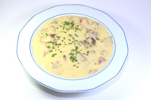 a bowl of soup with parsley on top of it