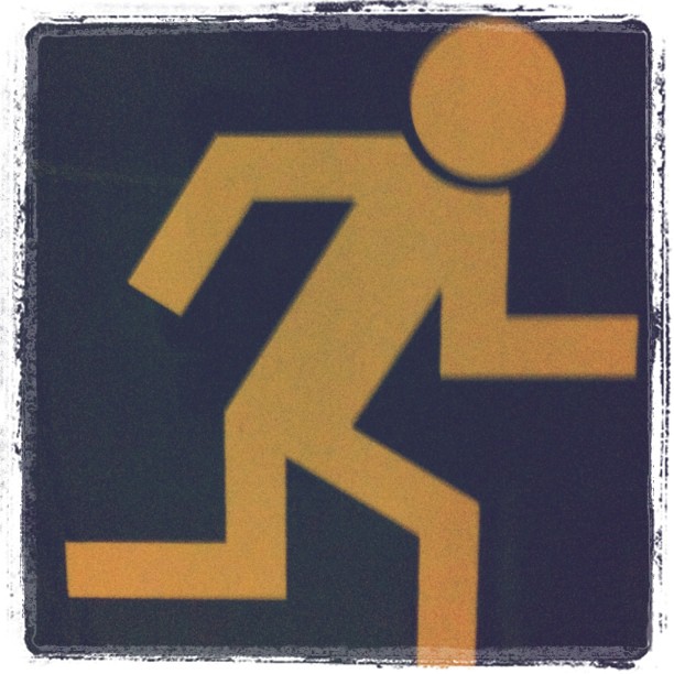 the sign shows a man with a yellow caution in his hand