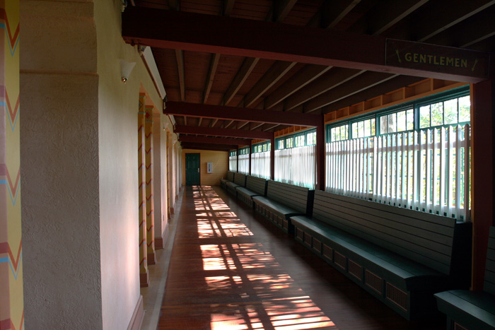 a long row of benches in a wooden structure