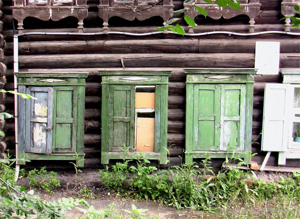 a log house that has a small set of windows