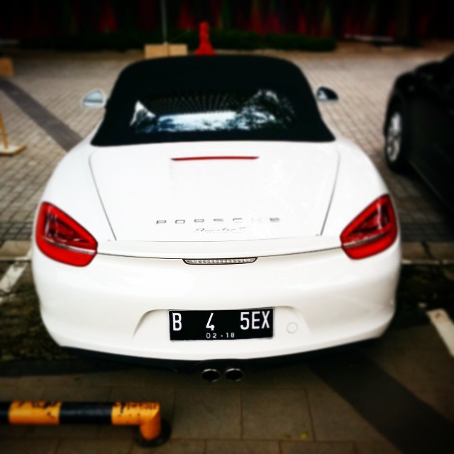 a white car parked on top of a parking meter