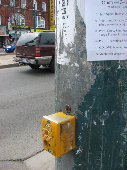a pole with a sign on it attached to a street corner