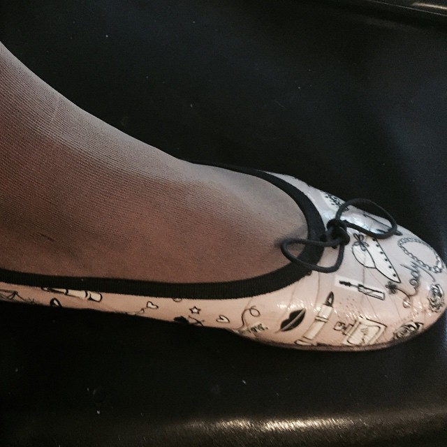 a woman's white shoes with black and white designs