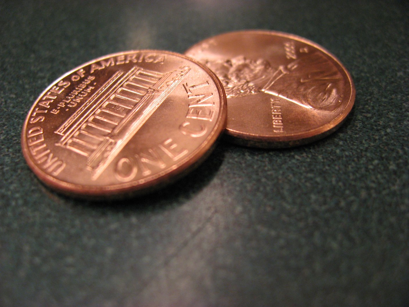 a close up of two american copper coin