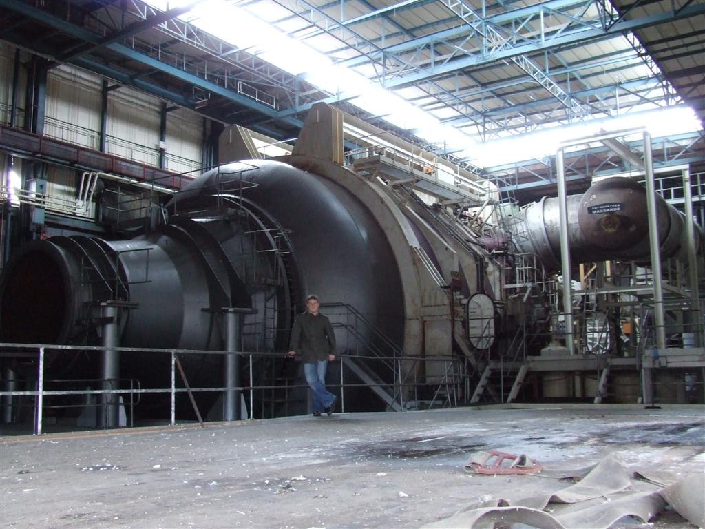 a man is standing inside a large metal machine