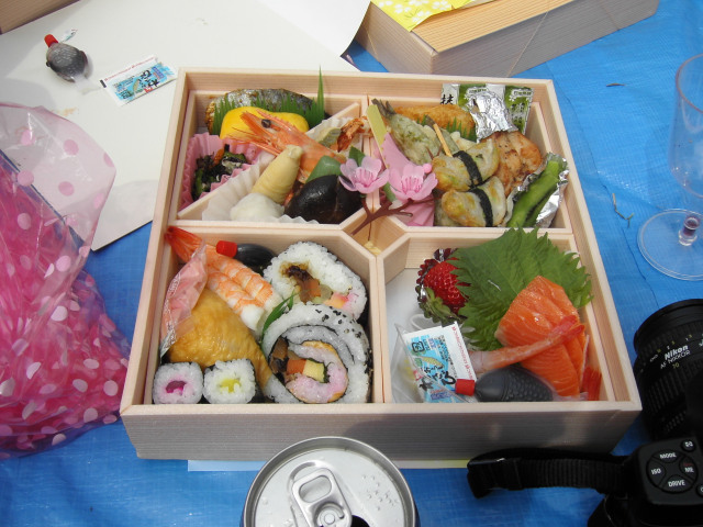assorted sushi in a box sitting on top of a table