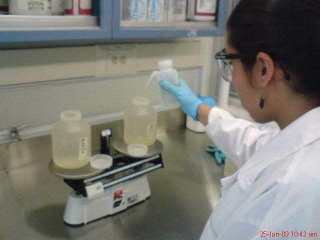 a woman in glasses and lab coats is preparing urine