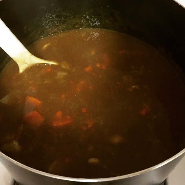 a pot full of soup with a spoon in it